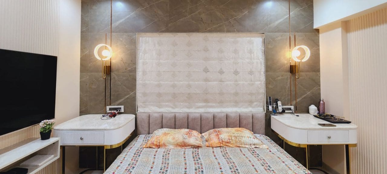 Modern bedroom featuring a stylish lamp, contemporary headboard, and integrated TV unit.