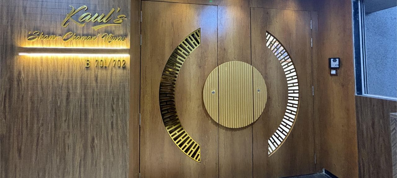Stylish main entry door of a home, featuring an illuminated nameplate with LED lighting.